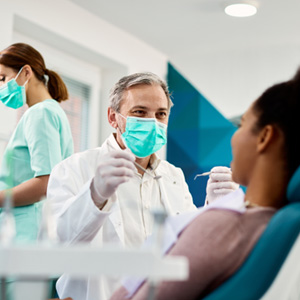 Dentist smiling at patient in treatment chair